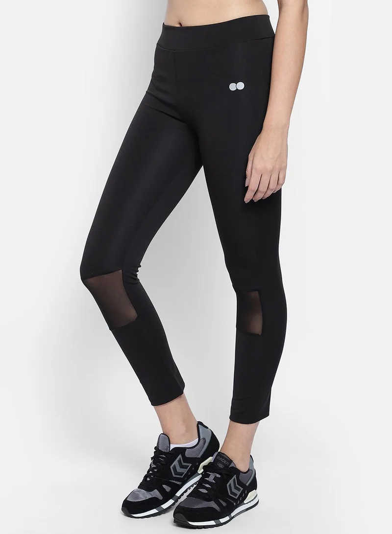 Clovia Black Snug Fit Active Tights in Black with Reflective Logo for Women | Best Price UAE